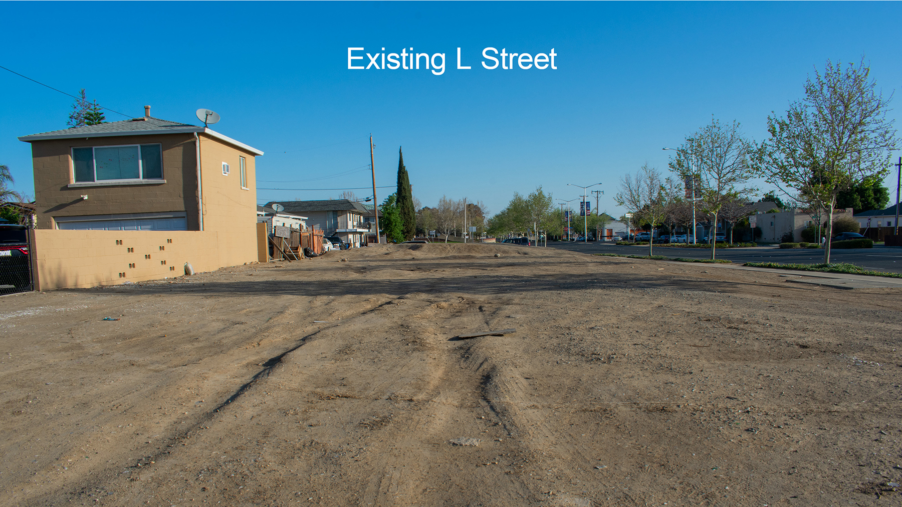 A slide for the Veterans Blvd Presenation, a photograph of one of the empty lots on L Street